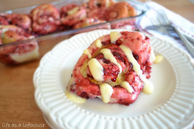 Raspberry Orange Rolls are soft and warm rolls full of raspberry and orange flavor with a drizzle of cream cheese frosting. Life-in-the-Lofthouse.com