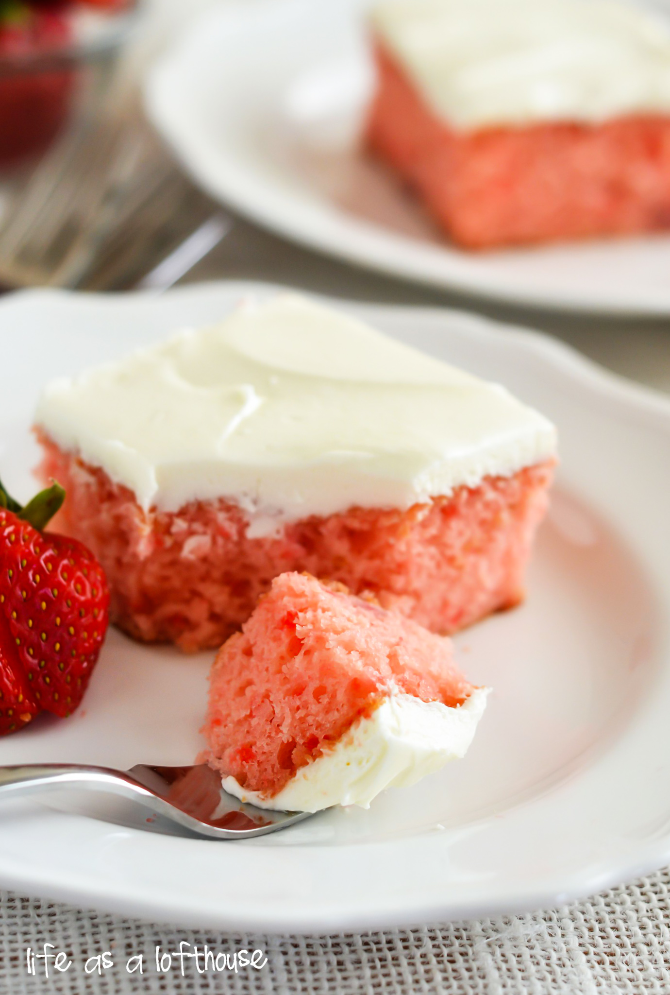 This Strawberry Cake is a soft and moist strawberry cake with real strawberries inside and is topped off with a rich and delicious cream cheese frosting. Life-in-the-Lofthouse.com