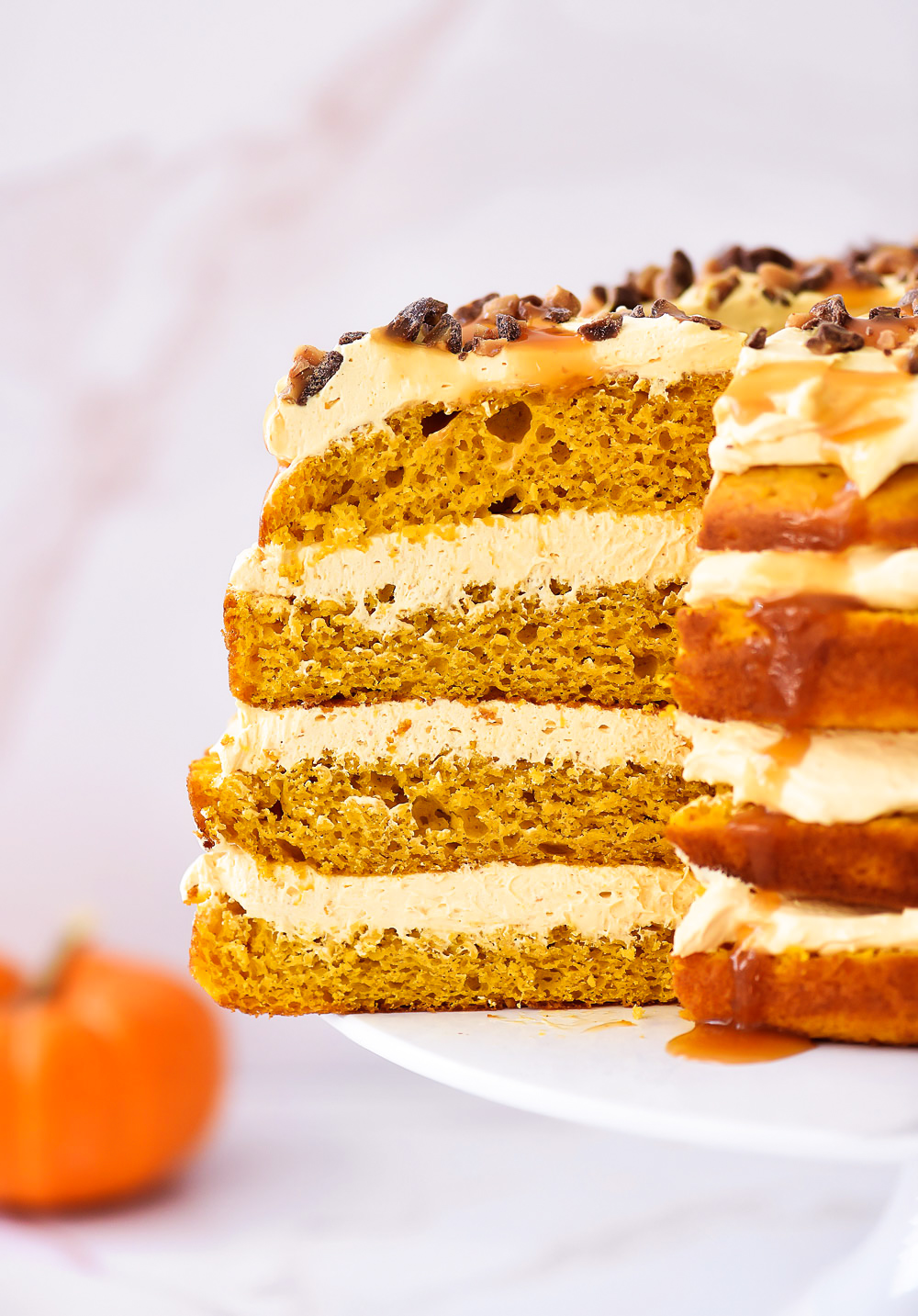 Pumpkin Torte has pumpkin cake layers with pumpkin whipped cream and is topped with loads of caramel sauce and toffee. Life-in-the-Lofthouse.com