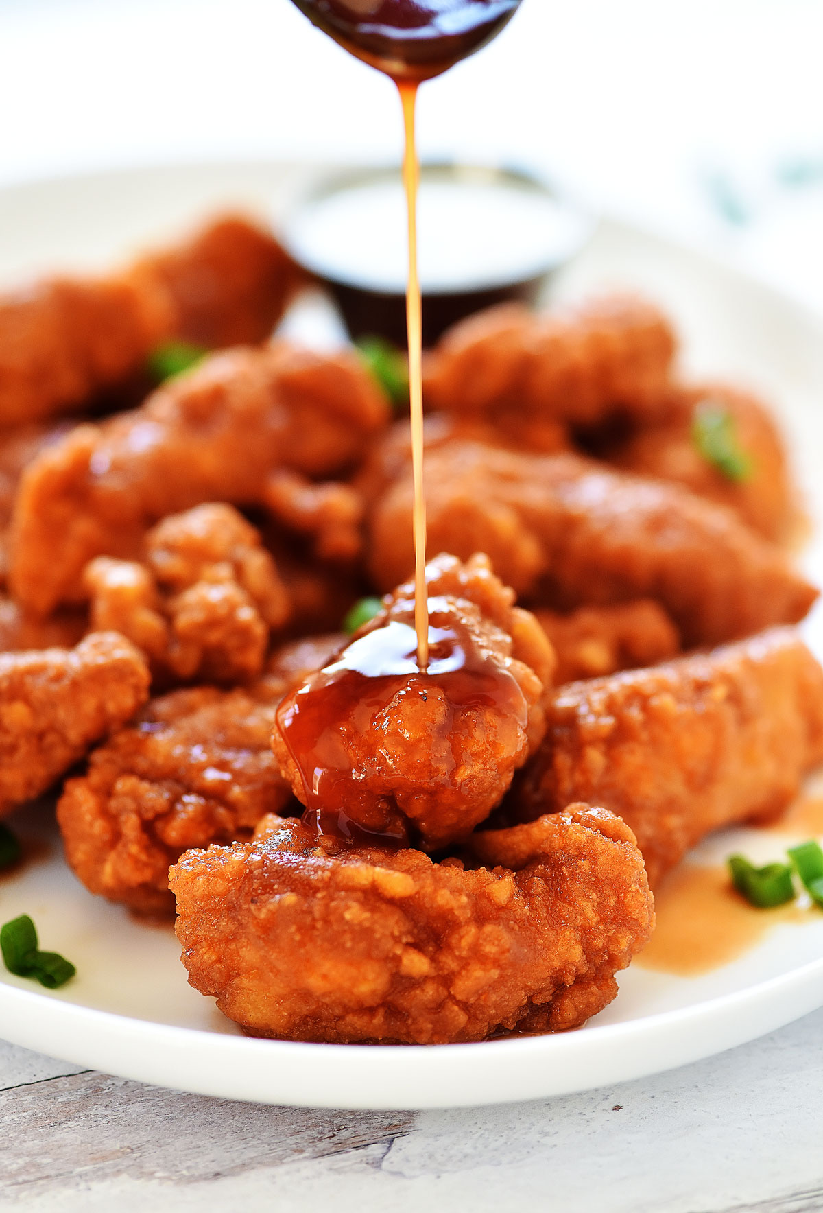 Sticky Chicken Fingers are crispy chicken tenders coated in a sweet and spicy glaze. Life-in-the-Lofthouse.com