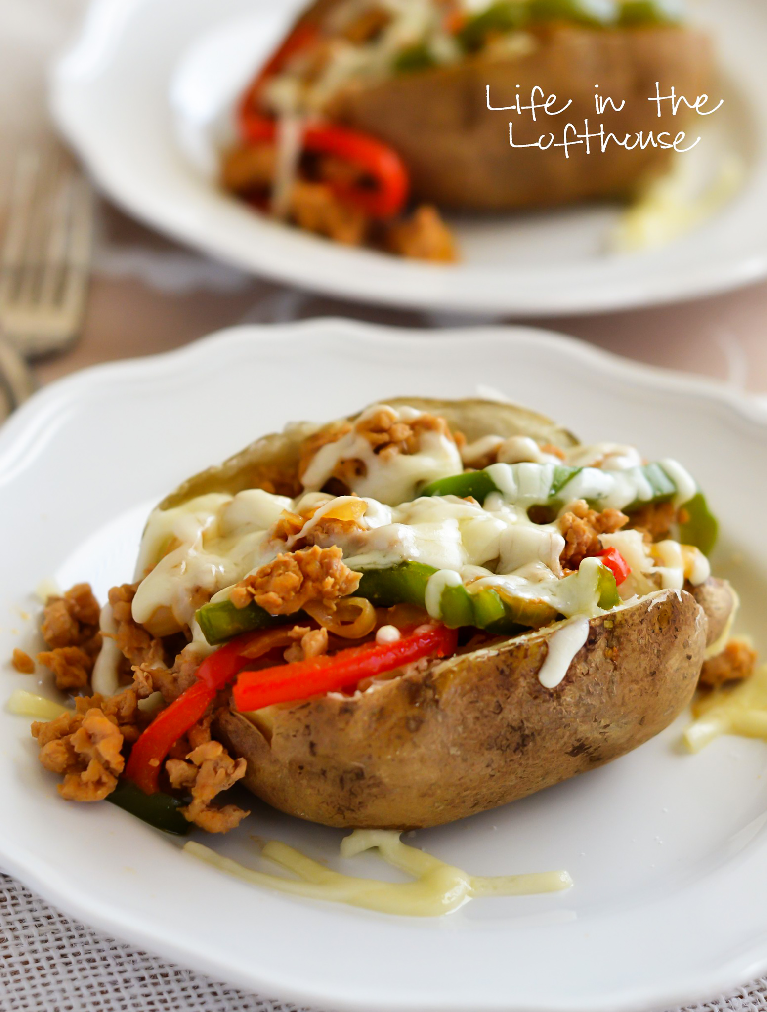 Baked Potatoes topped with a chicken cheesesteak filling. Life-in-the-Lofthouse.com