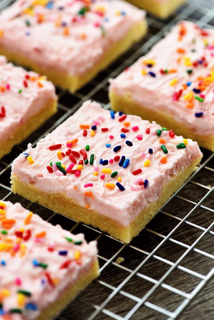 Sugar Cookie Bars are soft, thick sugar cookies in bar form with a delicious, creamy frosting. Life-in-the-Lofthouse.com