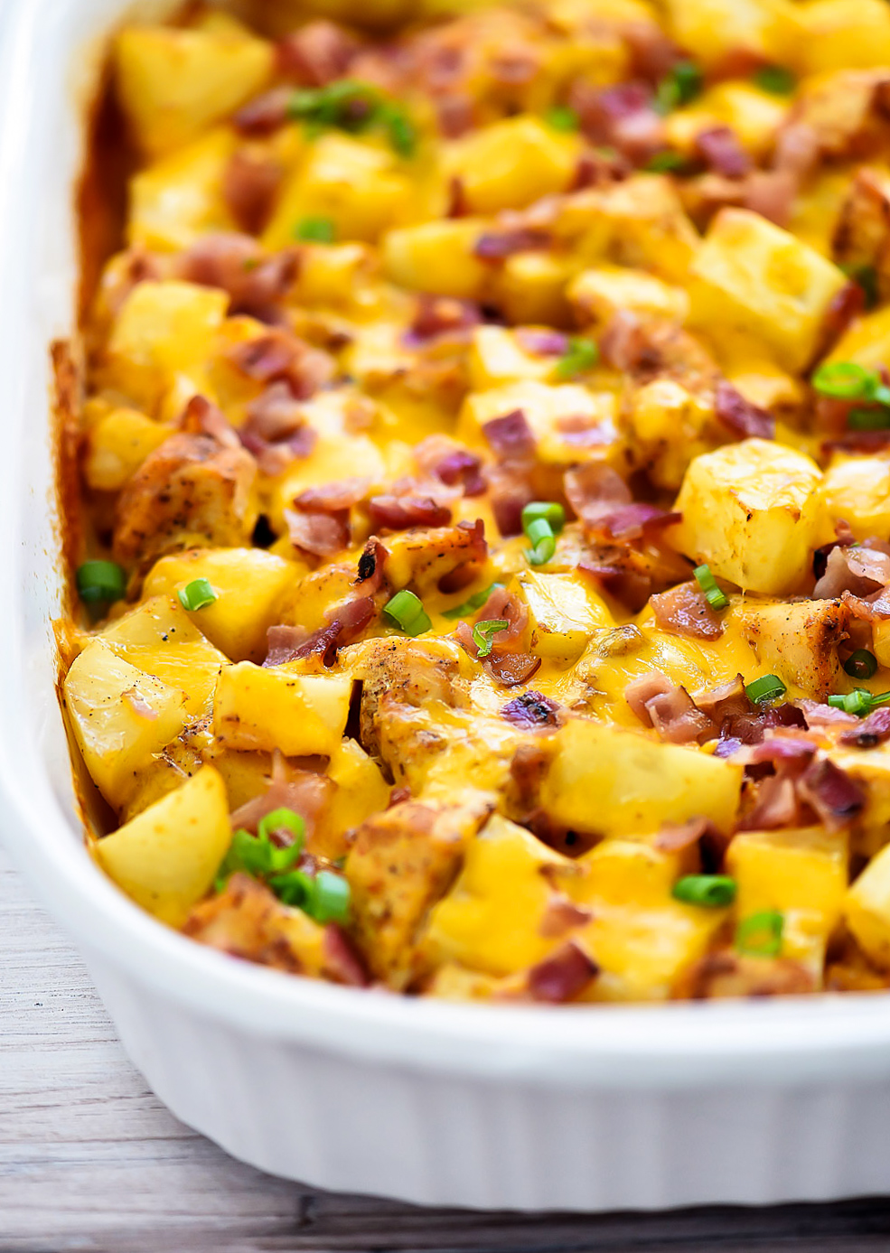 Loaded Chicken and Potato Casserole is seasoned chicken and potatoes that are baked together and then topped with bacon, cheese and green onion. Life-in-the-Lofthouse.com