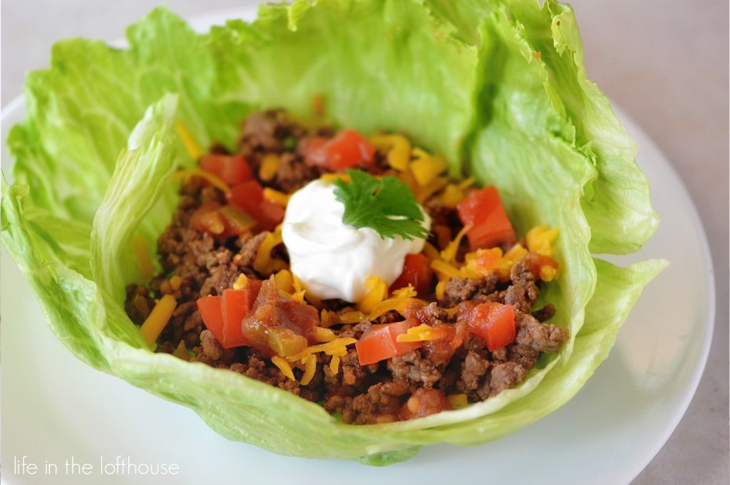 Taco lettuce wraps are taco seasoned ground beef, tomatoes, cheese and sour cream wrapped up inside lettuce leaves. Life-in-the-Lofthouse.com
