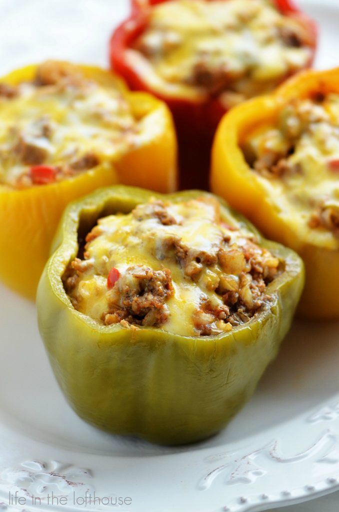 Crock Pot Stuffed Bell Peppers are cooked in the crock pot and filled with ground beef, Mexican rice, enchilada sauce and cheese. Life-in-the-Lofthouse.com