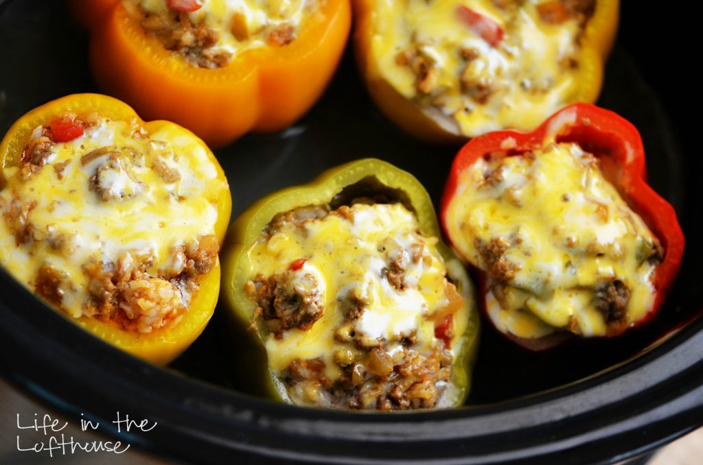Crock Pot Stuffed Bell Peppers are cooked in the crock pot and filled with ground beef, Mexican rice, enchilada sauce and cheese. Life-in-the-Lofthouse.com
