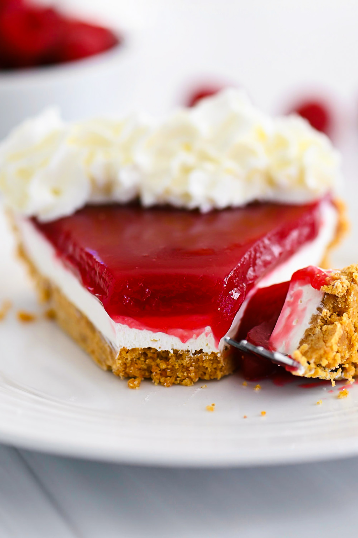Raspberry Cream Pie has a graham cracker crust, cream cheese filling and raspberry topping!
