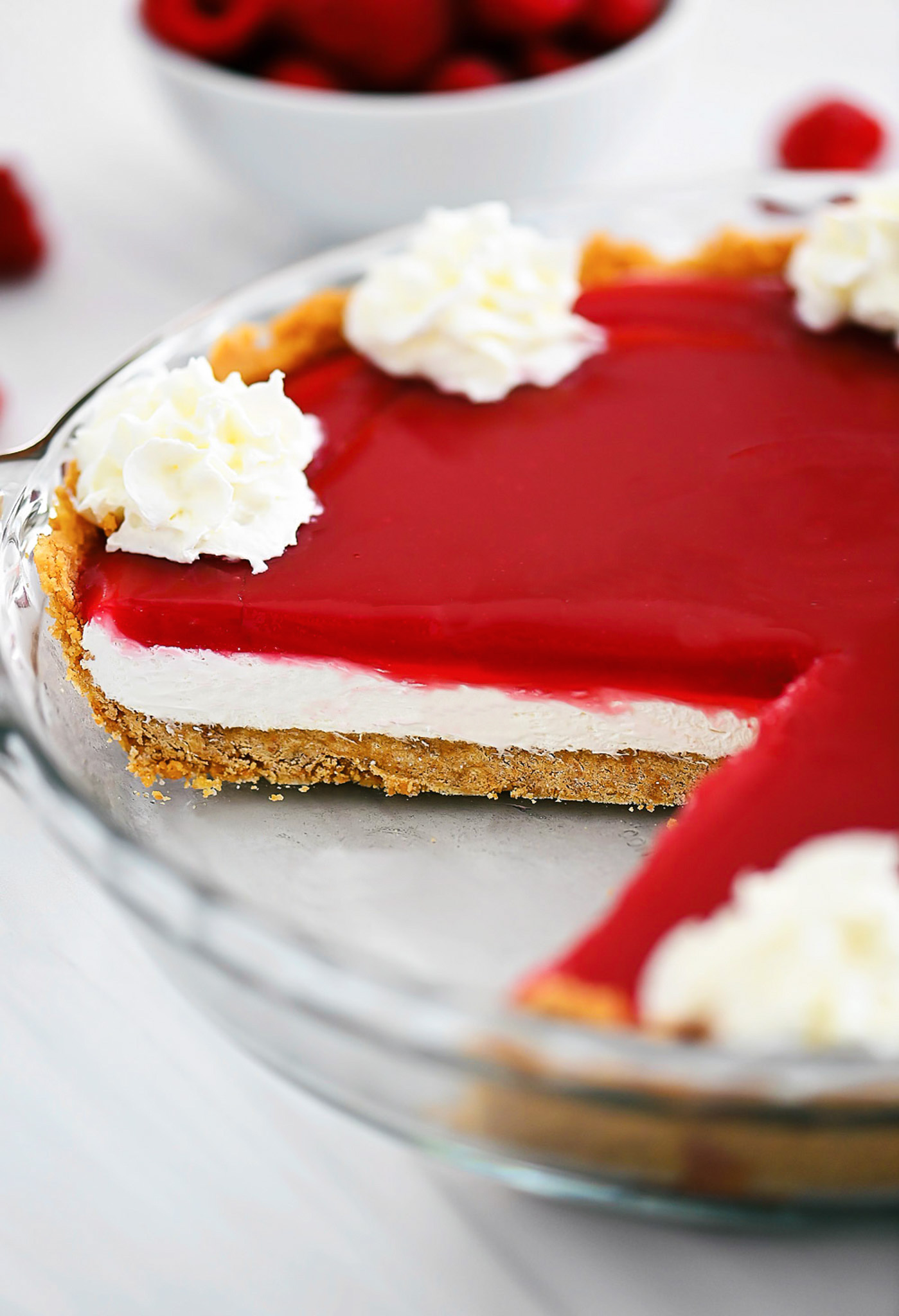 Raspberry Cream Pie has a graham cracker crust, cream cheese filling and raspberry topping!