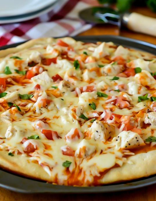 Creamy mild enchilada sauce, grilled chicken, loads of mozzarella cheese and diced tomato and cilantro make up this delicious chicken enchilada pizza. Life-in-the-Lofthouse.com