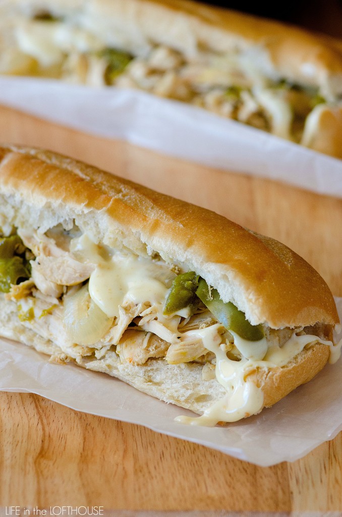 Savory chicken is slow cooked in chicken broth, spices, onions and bell peppers to create these incredible Crock Pot Chicken Cheesesteak Sandwiches. Life-in-the-Lofthouse.com