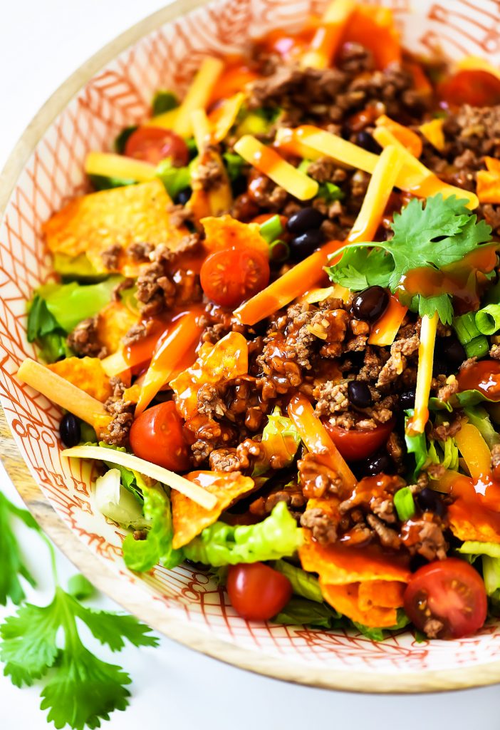 This Doritos Taco Salad is loaded with seasoned ground beef, black beans and of course, Nacho Cheese Doritos. Life-in-the-Lofthouse.com