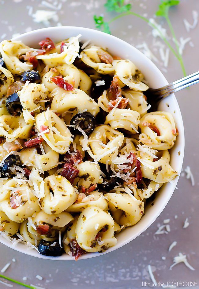 Pesto Tortellini Salad is cheese tortellini pasta coated in pesto, bacon and olives. Life-in-the-Lofthouse.com