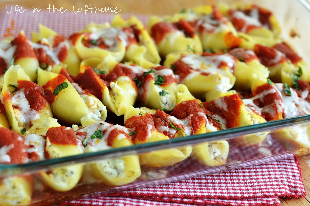 Chicken stuffed shells with pesto and cheese.