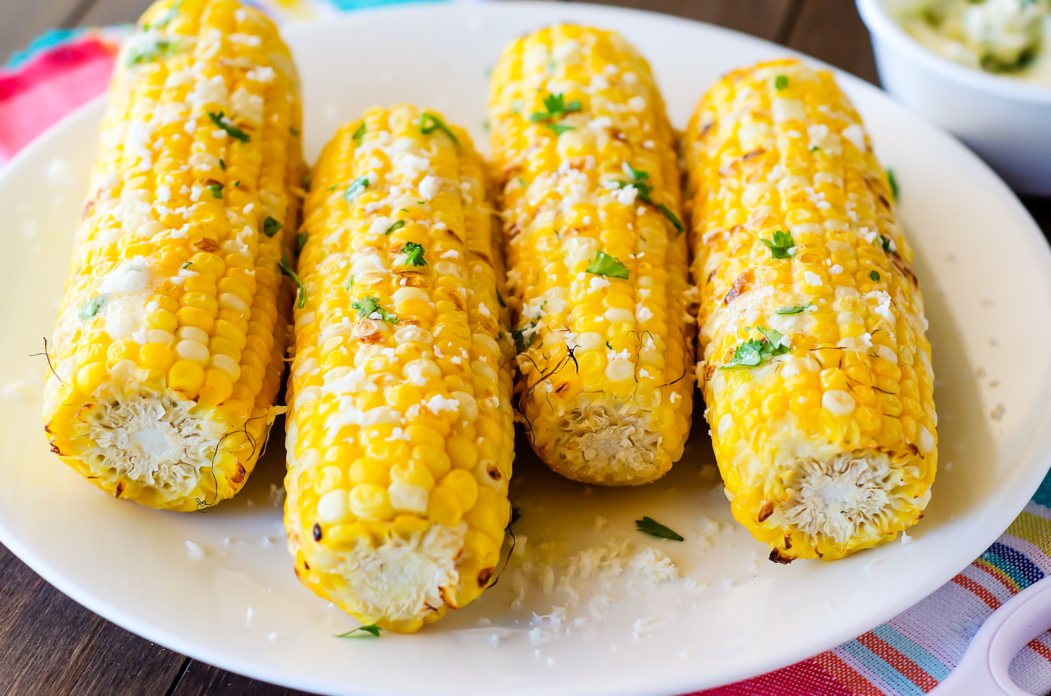 Grilled fresh corn covered in a delicious cilantro-lime butter. Life-in-the-Lofthouse.com