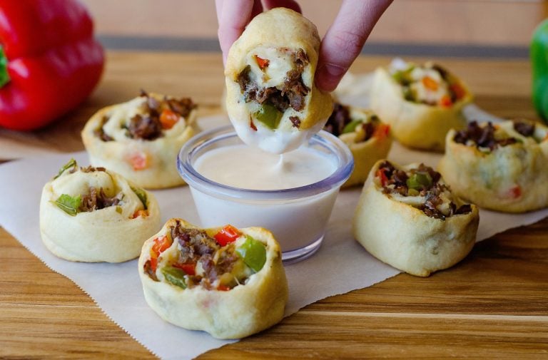 Philly cheese steak crescent pinwheels are filled with steak, cream cheese and bell peppers that are wrapped up in flaky crescent dough. Life-in-the-Lofthouse.com
