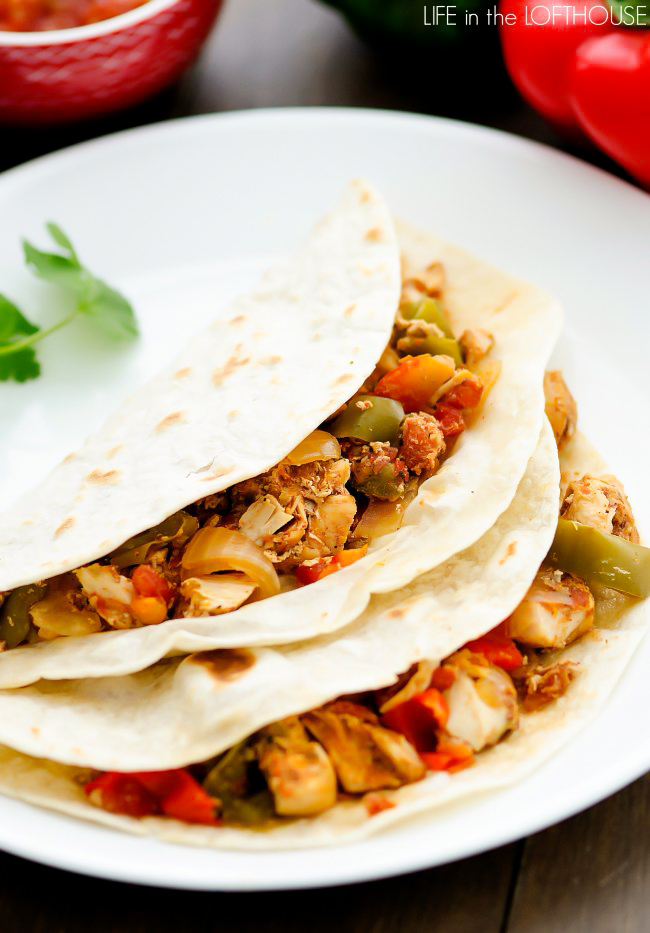 Chicken, bell peppers, onion and an assortment of Mexican spices make up these flavorful Crock Pot chicken fajitas. Life-in-the-Lofthouse.com