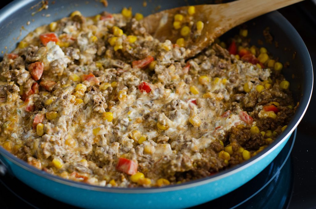 A delicious skillet with noodles, ground beef, olives and red bell peppers with taco seasonings. Life-in-the-Lofthouse.com