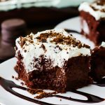 This incredible Thin Mint Chocolate Poke Cake is filled with chocolate pudding, crushed thin mint cookies and topped with a creamy peppermint whipped topping. Life-in-the-Lofthouse.com