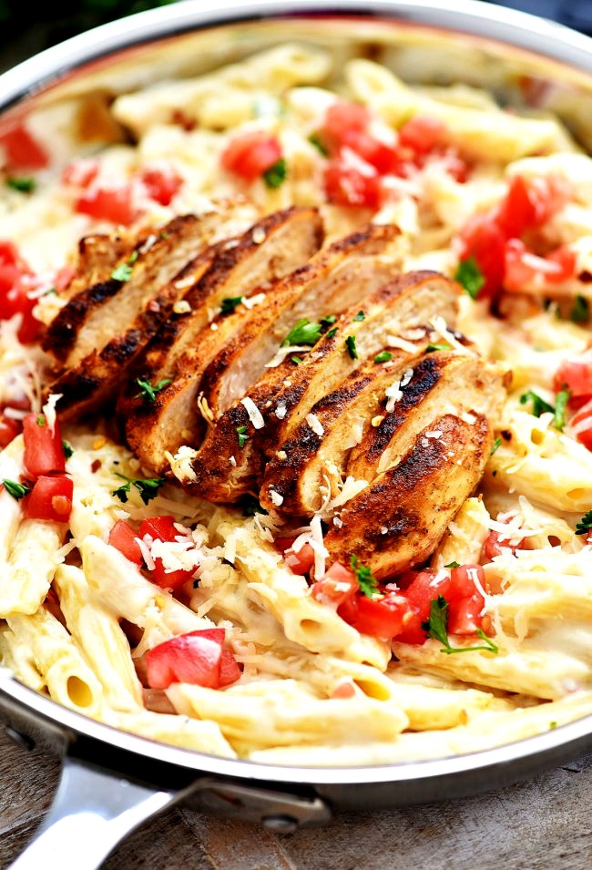 Cajun-chicken, tomatoes and Parmesan Cheese topped over a bed of creamy penne pasta. Life-in-the-Lofthouse.com