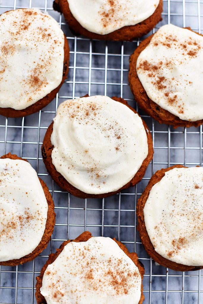 Maple cream frosting pairs perfectly with pumpkin chocolate chip cookies!