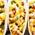 Breakfast Tacos filled with scrambled eggs, crispy bacon, seasoned potatoes and drenched in Queso cheese sauce. Life-in-the-Lofthouse.com