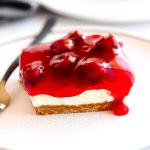 Cherry Delight is an easy dessert recipe with a graham cracker crust, a cheesecake center and topped off with delicious cherry pie filling!