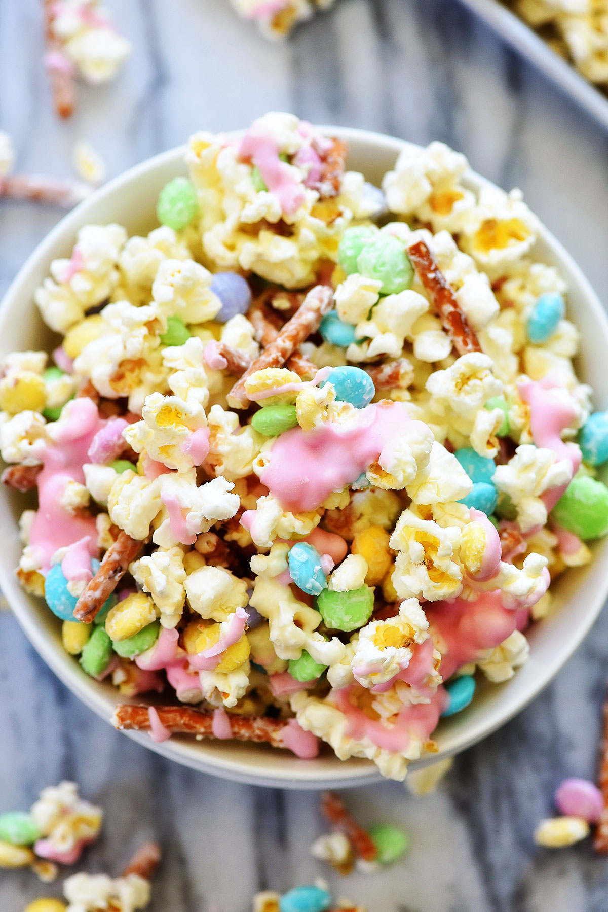 Bunny Bait is a delicious treat filled with popcorn, M&M candies and pretzels all coated in white chocolate. Life-in-the-Lofthouse.com 