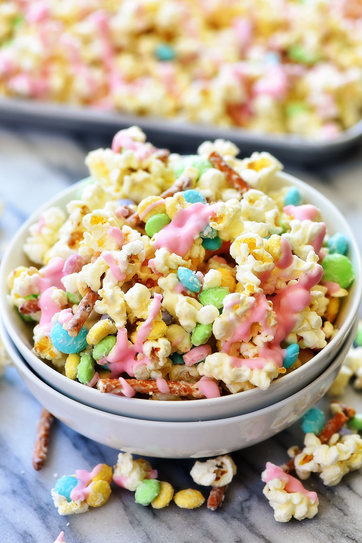 Bunny Bait is a delicious treat filled with popcorn, M&M candies and pretzels all coated in white chocolate. Life-in-the-Lofthouse.com