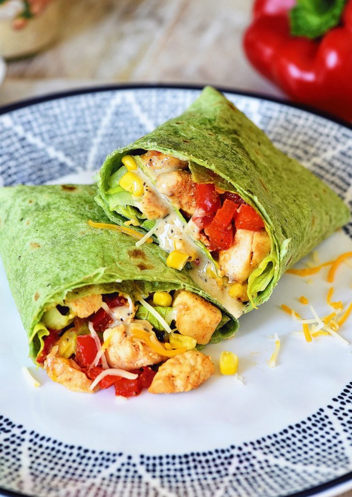 Southwest Chicken Caesar Wraps have tender seasoned chicken, black beans, corn, bell pepper and a few other goodies all wrapped up in a spinach tortilla. Life-in-the-Lofthouse.com