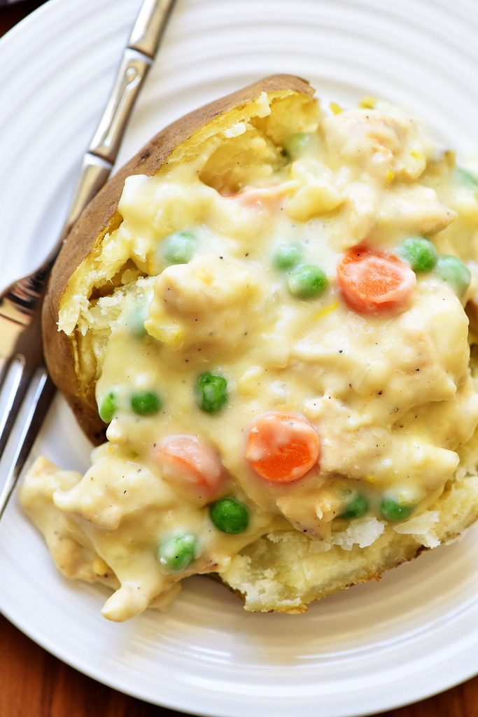 Chicken Pot Pie Baked Potato has a homemade creamy pot pie sauce that is drenched over a hot baked potato. Life-in-the-Lofthouse.com