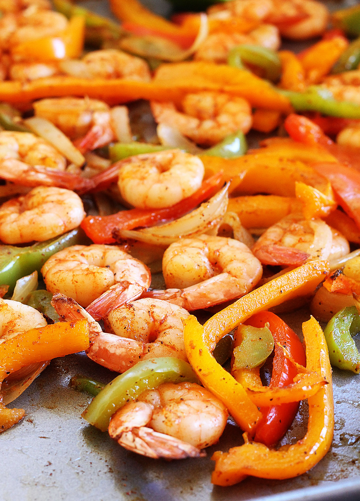 These sheet pan Shrimp Fajitas are slightly spicy and full of peppers and onions with hints of lime. Life-in-the-Lofthouse.com