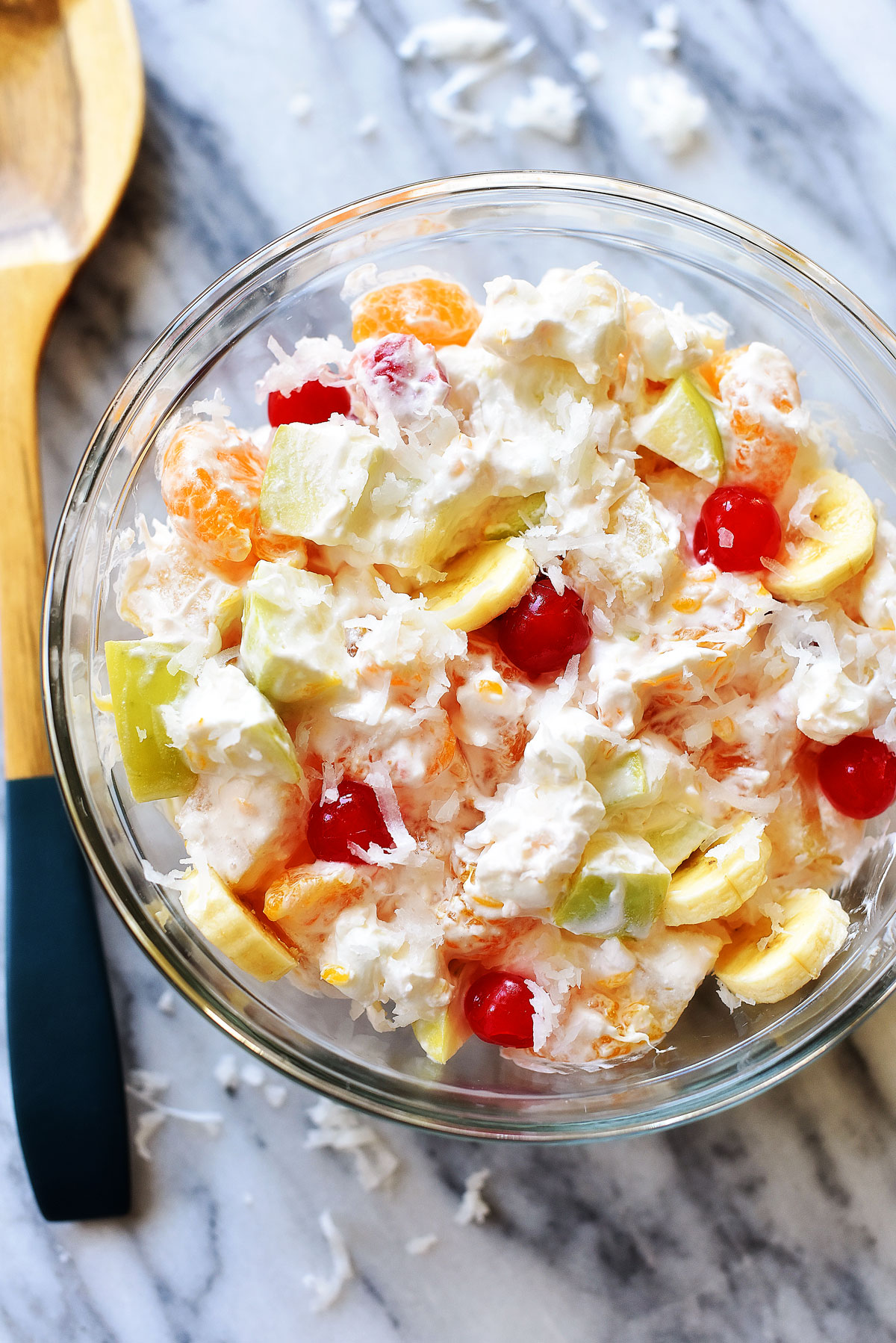 This Creamy Fruit Salad is filled with refreshing fruit, coconut shavings, marshmallows and whipped cream. Life-in-the-Lofthouse.com