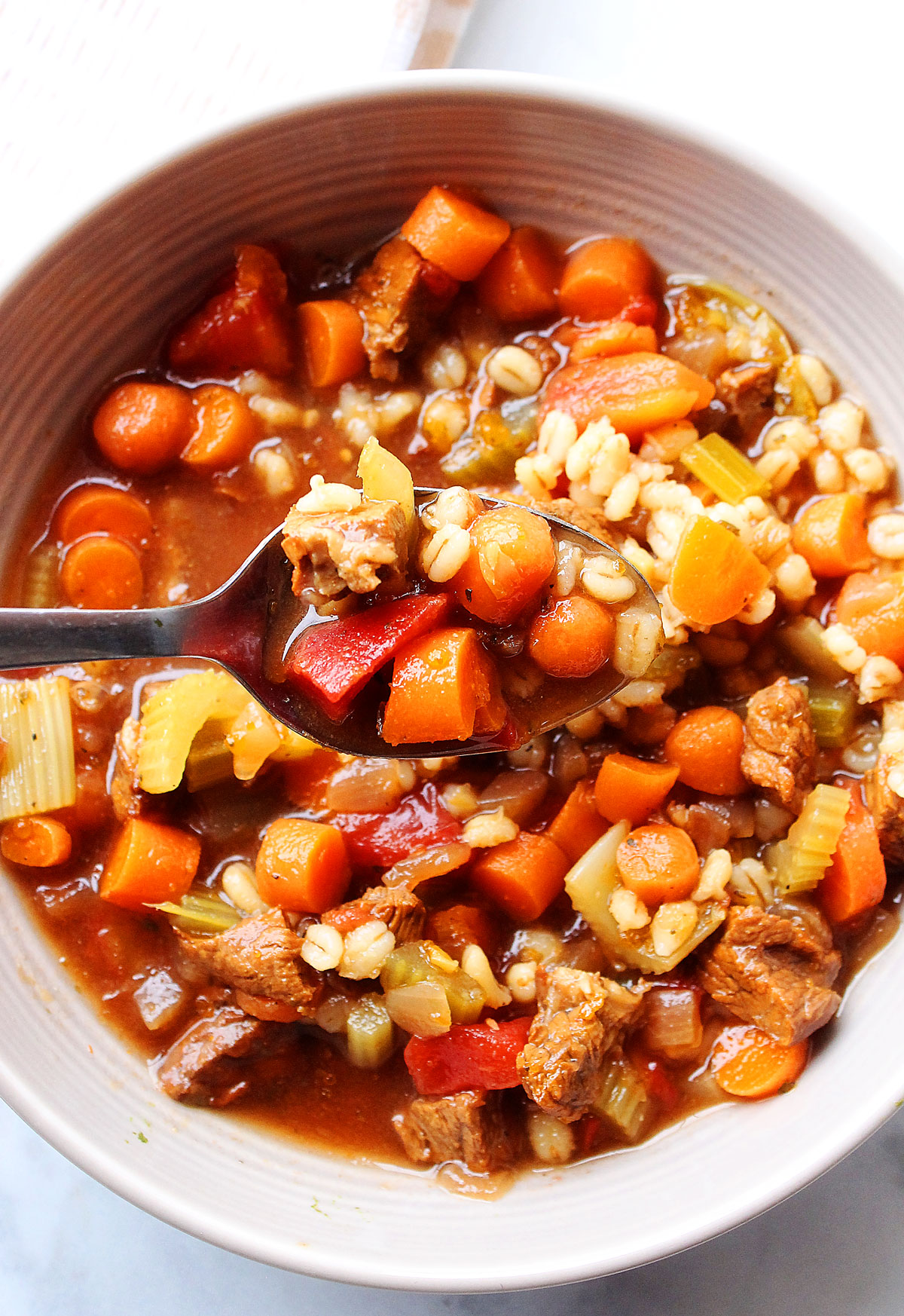 Slow Cooker Beef Barley Soup is a delicious soup full of tasty beef chunks, bits of barley, and tons of vegetables. Life-in-the-Lofthouse.com