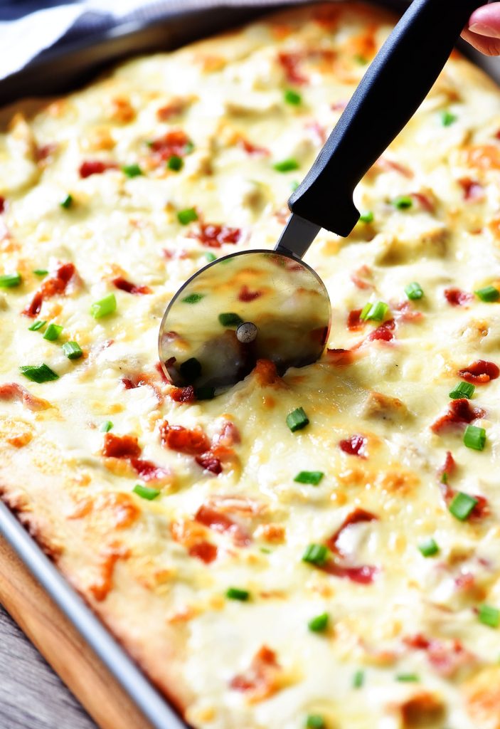 Sheet Pan Chicken Alfredo Pizza is a simple homemade pizza dough topped with creamy Alfredo sauce, grilled chicken, bacon and Mozzarella cheese. Life-in-the-Lofthouse.com
