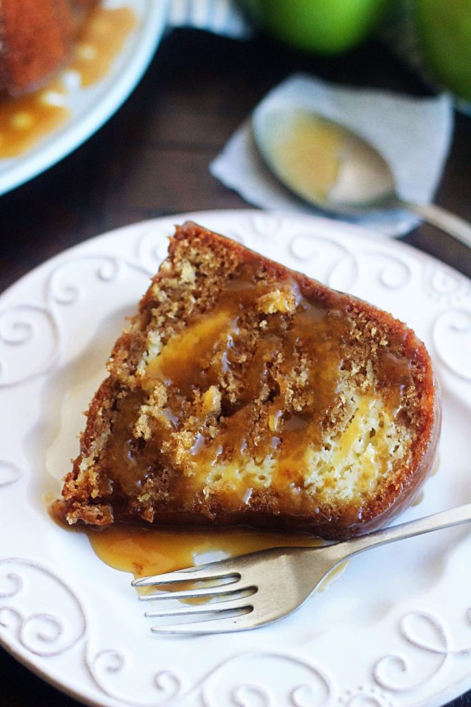 Apple Bundt cake with Cream Cheese Swirl is a moist, delicious apple bundt cake filled with cream cheese and topped with a caramel sauce. Life-in-the-Lofthouse.com
