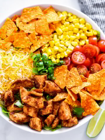 Doritos Chicken Taco Salad is filled with seasoned grilled chicken, corn, tomatoes, cheese and nacho cheese Doritos. Life-in-the-Lofthouse.com