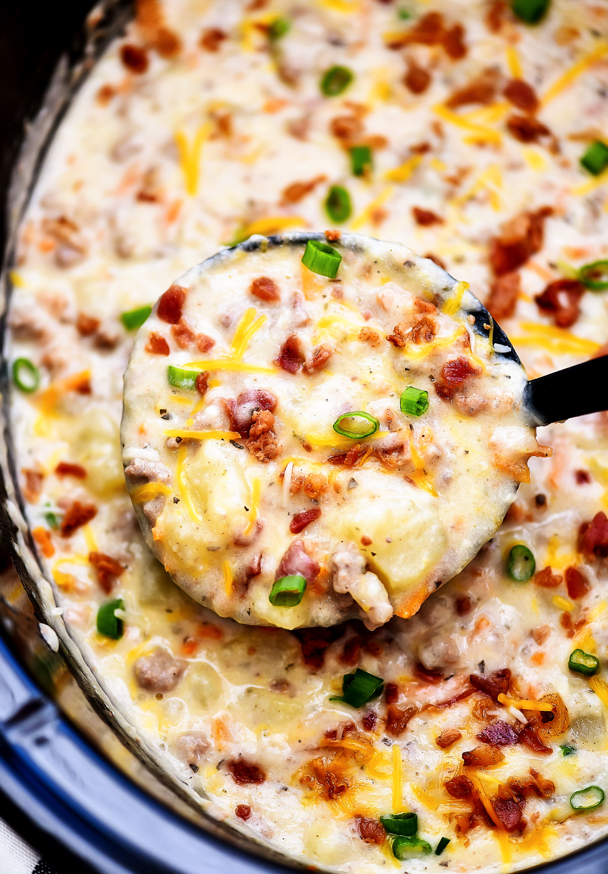 Bacon Cheeseburger soup is slow cooked soup loaded with potatoes, ground beef, cheese and bacon. Life-in-the-Lofthouse.com