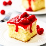 Raspberry Cream Cake is a moist and delicious white cake with a whipped cream cheese layer and raspberry glaze topping. These wonderful flavors together are amazing!