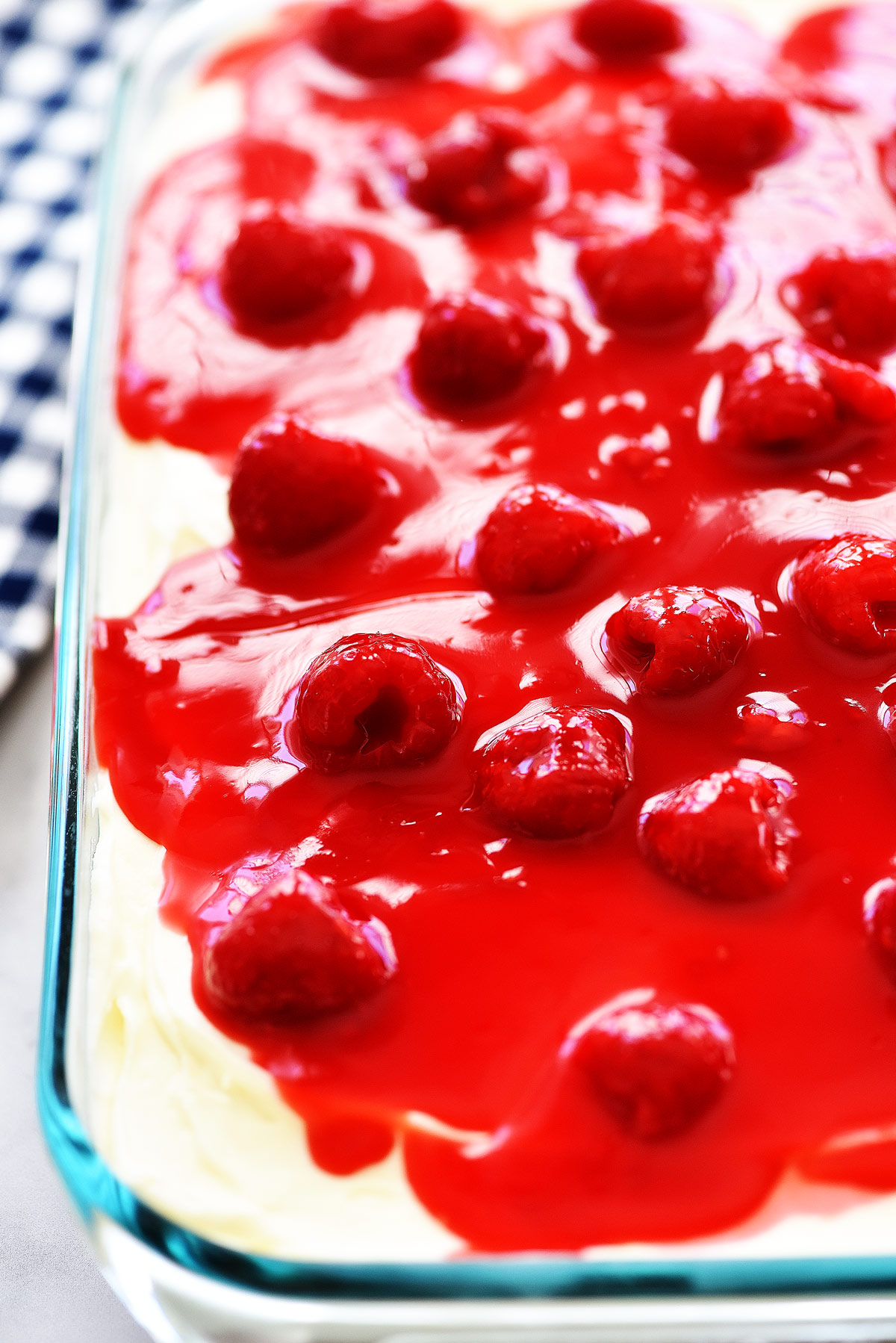 Raspberry Cream Cake is a moist and delicious white cake with a whipped cream cheese layer and raspberry glaze topping. Life-in-the-Lofthouse.com