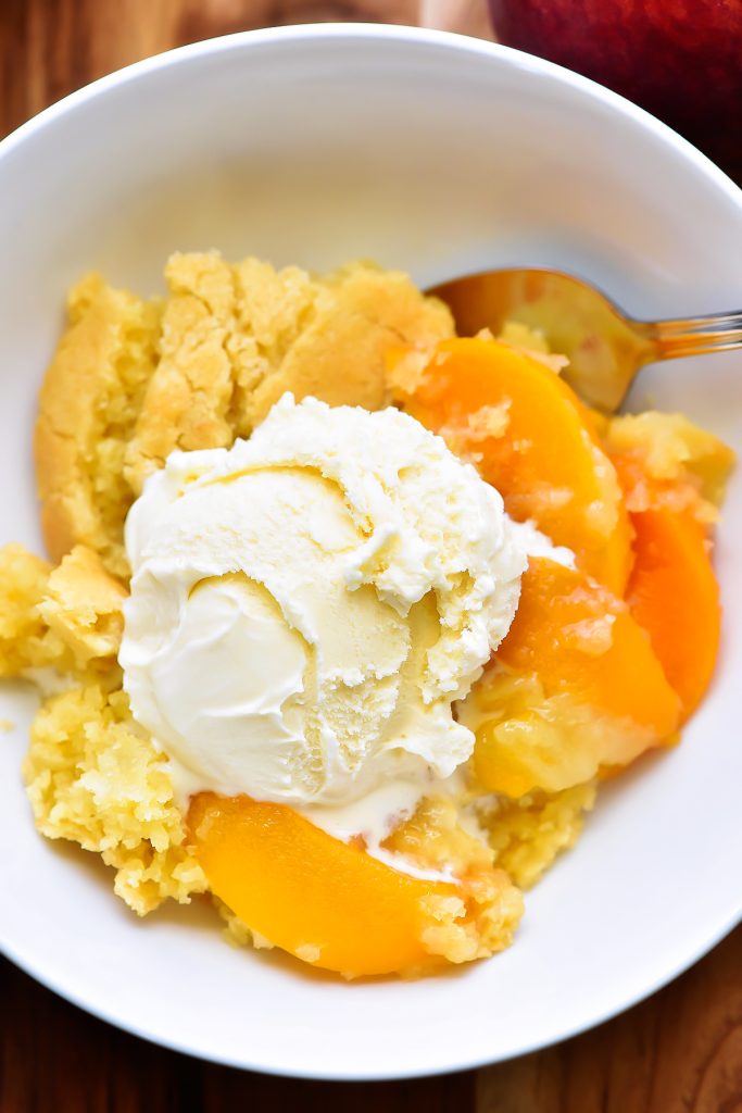 The Best Peach Cobbler is a delicious cake-like dessert made with sliced peaches and served warm with vanilla ice-cream. Life-in-the-Lofthouse.com