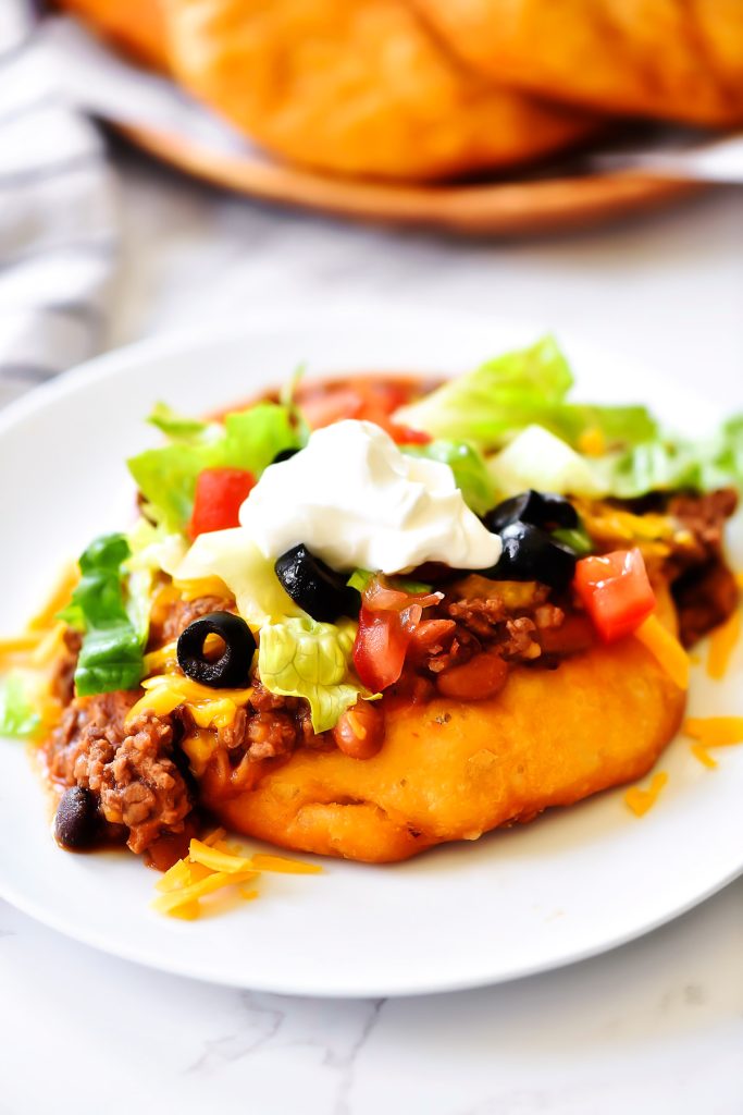 Easy Navajo Tacos are Indian fry breads topped with chili, cheese and all your favorite taco fixings. Life-in-the-Lofthouse.com
