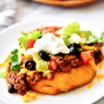 Easy Navajo Tacos are Indian fry breads topped with chili, cheese and all your favorite taco fixings. Life-in-the-Lofthouse.com