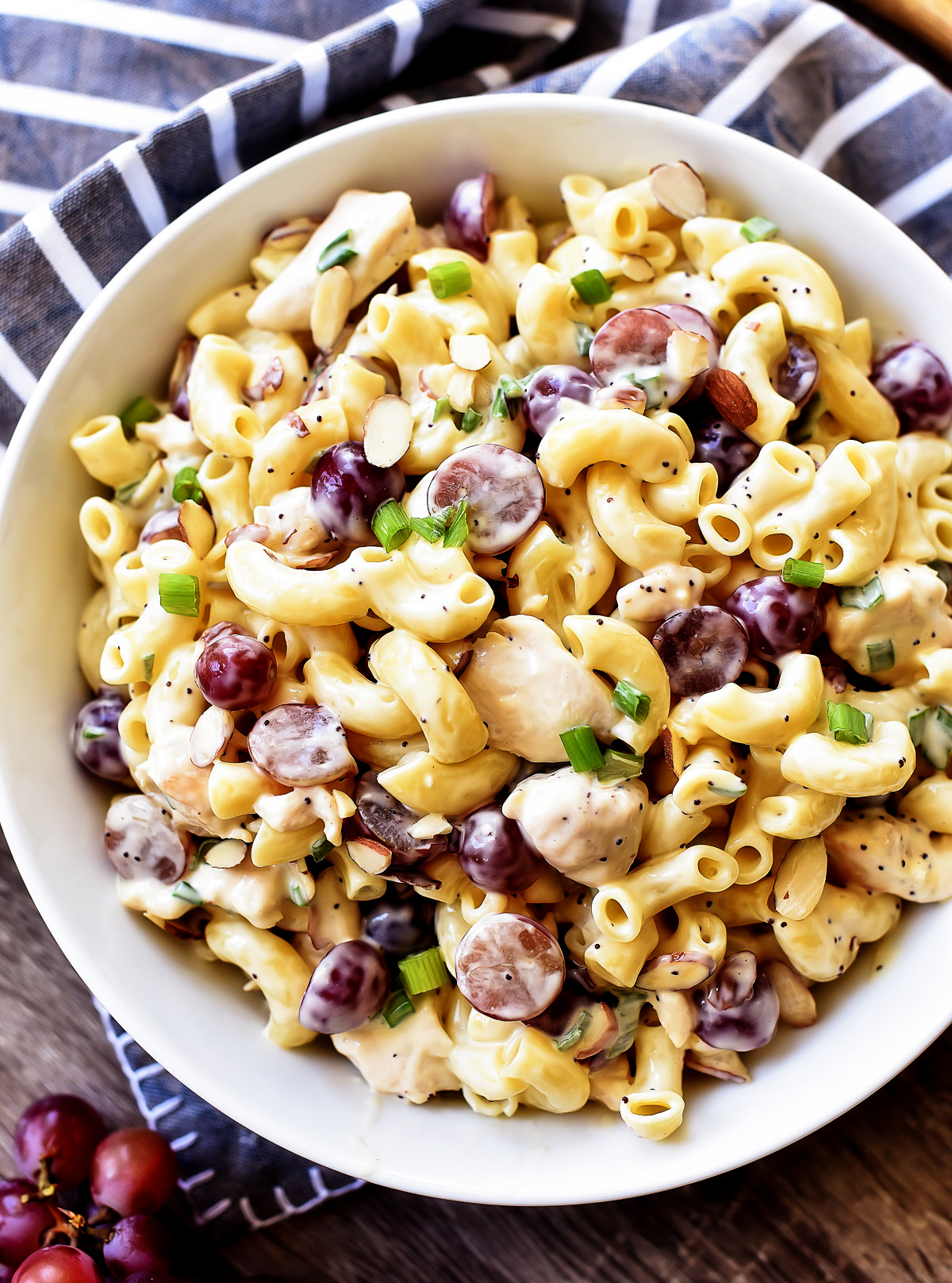 Poppy Seed Chicken Grape Pasta Salad is a pasta salad filled with seasoned chicken, pasta, grapes, green onion and covered in poppy seed dressing. Life-in-the-Lofthouse.com