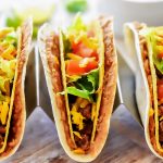 Double Decker Tacos start with a flour tortilla layered with beans, then inside there's a crispy beef taco filled with all your favorite taco toppings. Life-in-the-Lofthouse.com