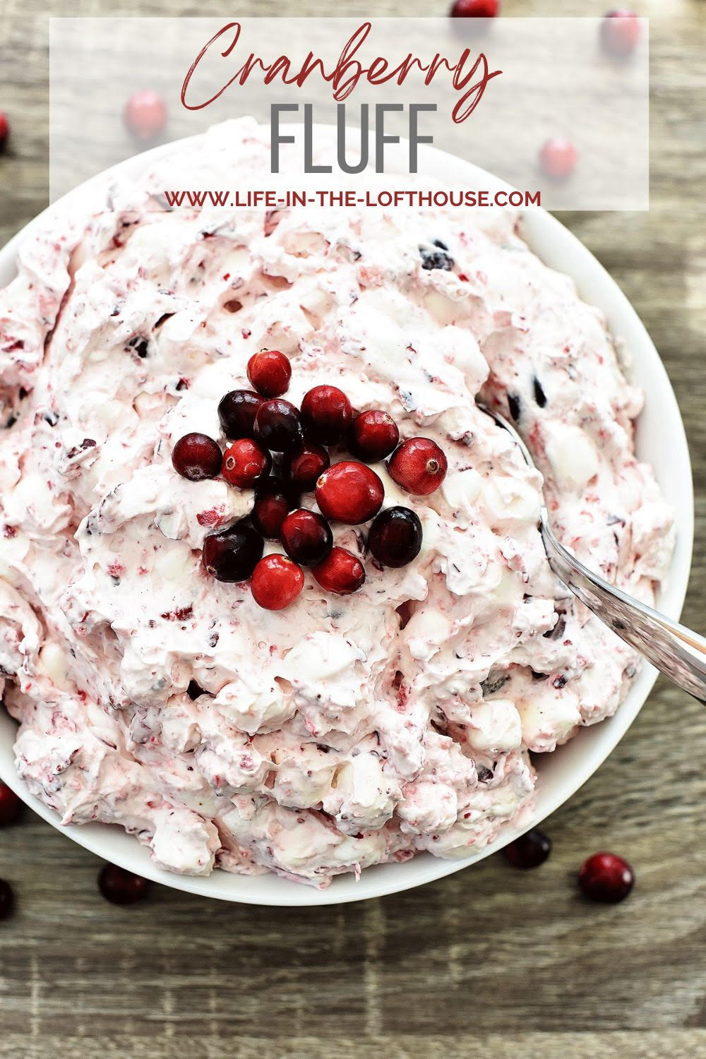 Cranberry Fluff is a creamy and sweet side dish filled with homemade whipped cream, cranberries, red grapes and marshmallows. Life-in-the-Lofthouse.com