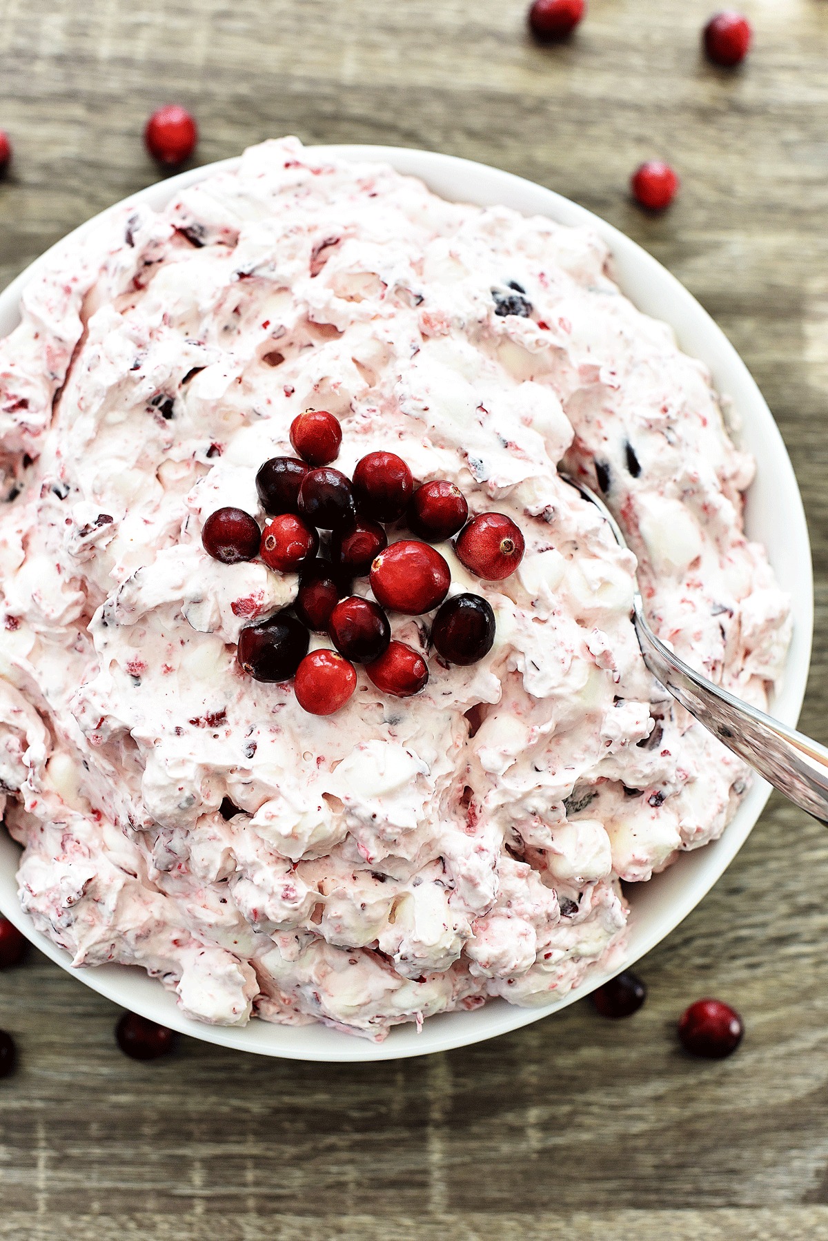 Cranberry Fluff is a creamy and sweet side dish filled with homemade whipped cream, cranberries, red grapes and marshmallows. Life-in-the-Lofthouse.com