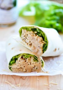 Crock Pot Chicken Caesar Wraps have flavorful Caesar chicken, lettuce and Parmesan cheese all wrapped up in a flour tortilla. Life-in-the-Lofthouse.com