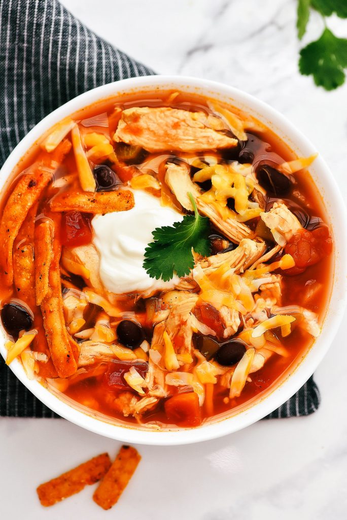 Slow Cooker Chicken Tortilla Soup has Mexican flavors with chicken, onion, tomato and diced green chilies. Life-in-the-Lofthouse.com