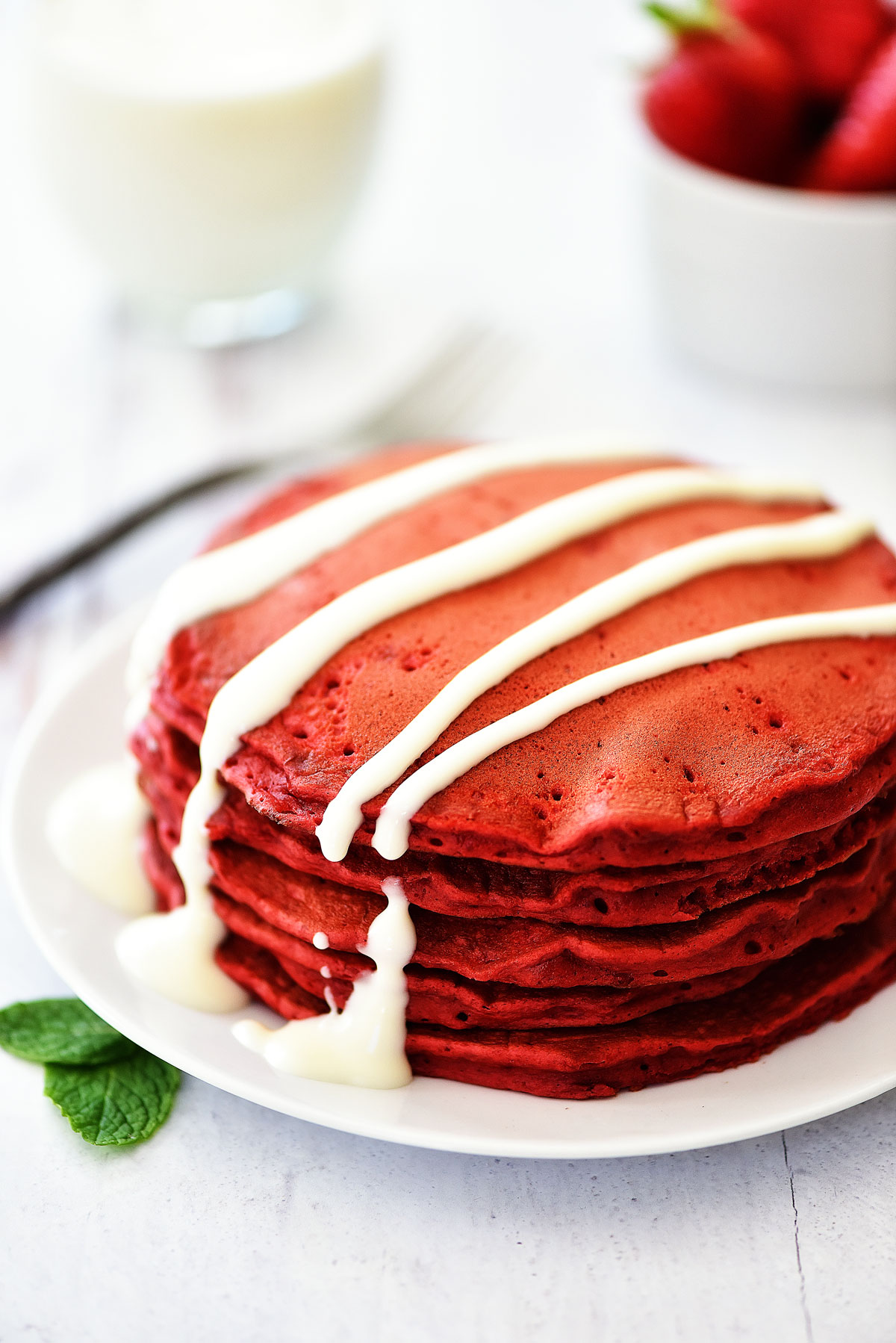Red Velvet Pancakes are light and fluffy bright red pancakes with an incredible cream cheese glaze to drizzle over the tops. Life-in-the-Lofthouse.com