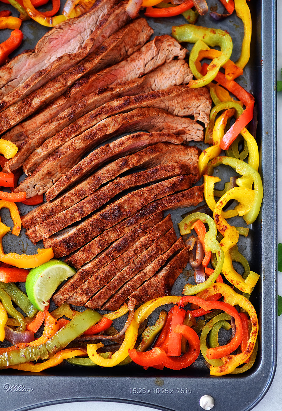 Sheet Pan Steak Fajitas are just like classic fajitas with grilled onions, bell peppers and steak. Life-in-the-Lofthouse.com